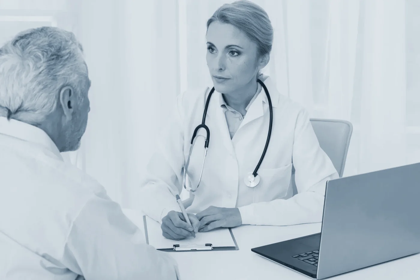 A doctor talking a patient through their consultation