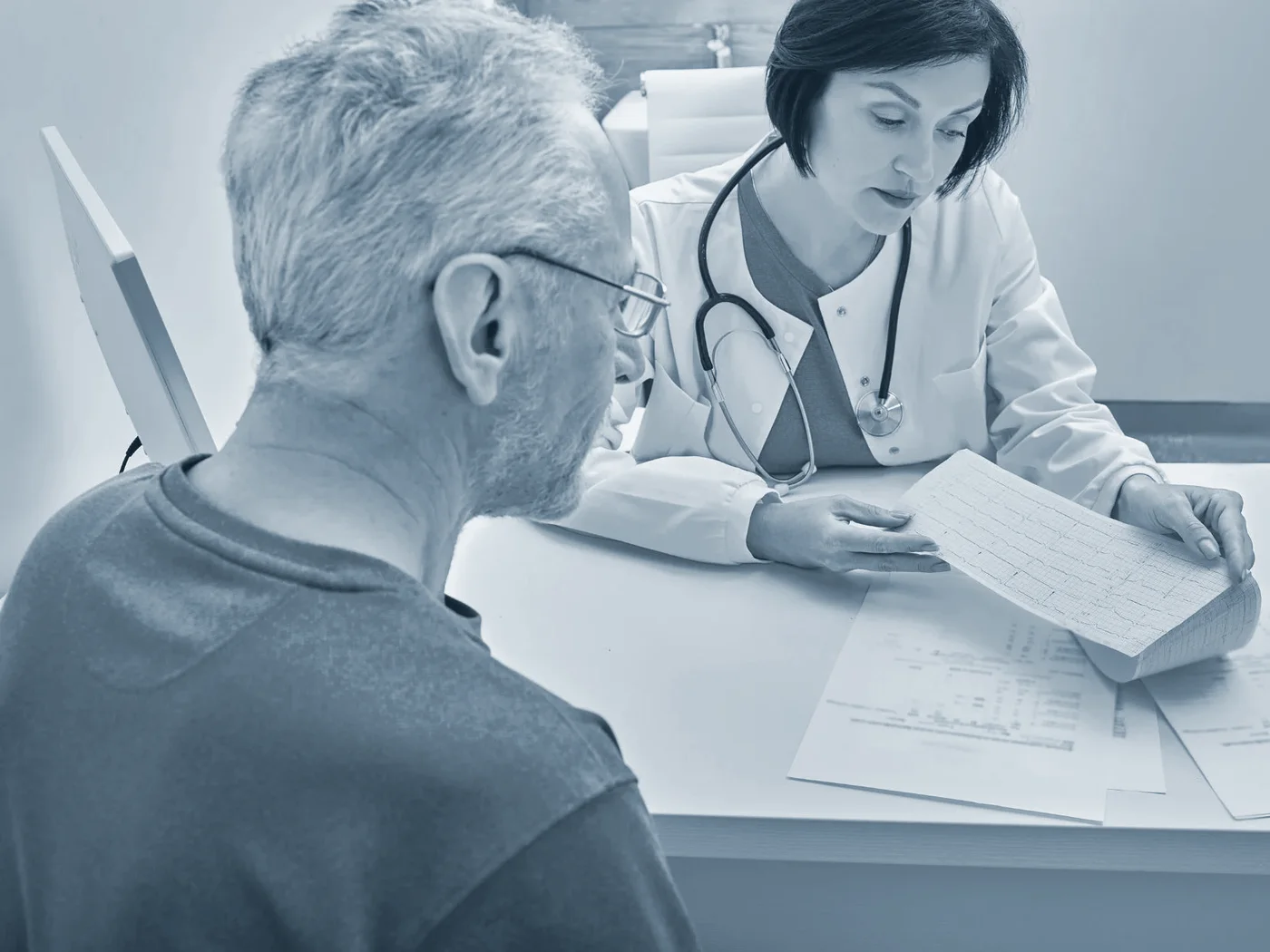 A clinician and patient reviewing an ECG strip together